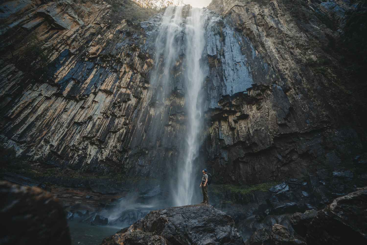 Man standing at the base of Minyon Falls