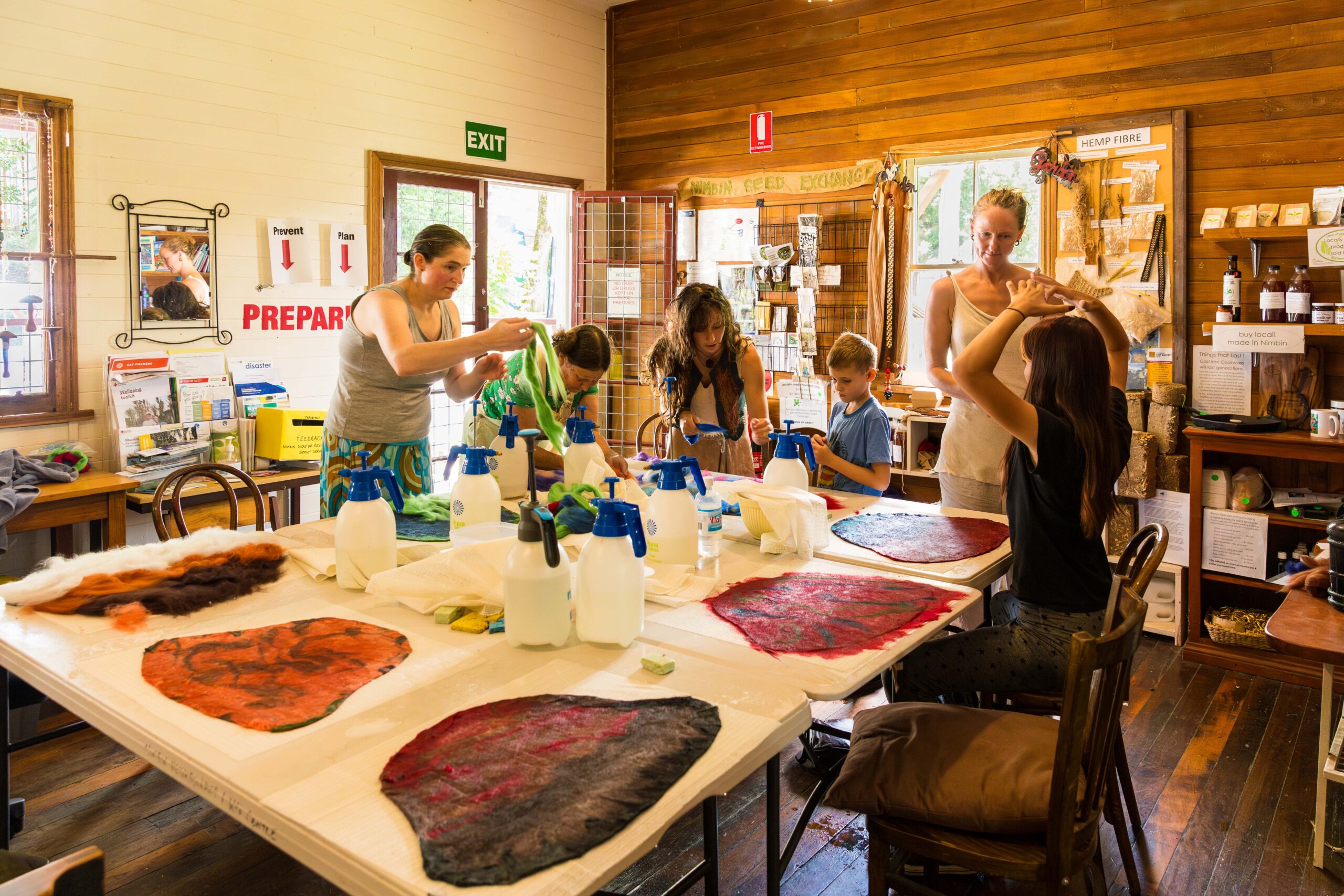 A group learning how to make felt hats